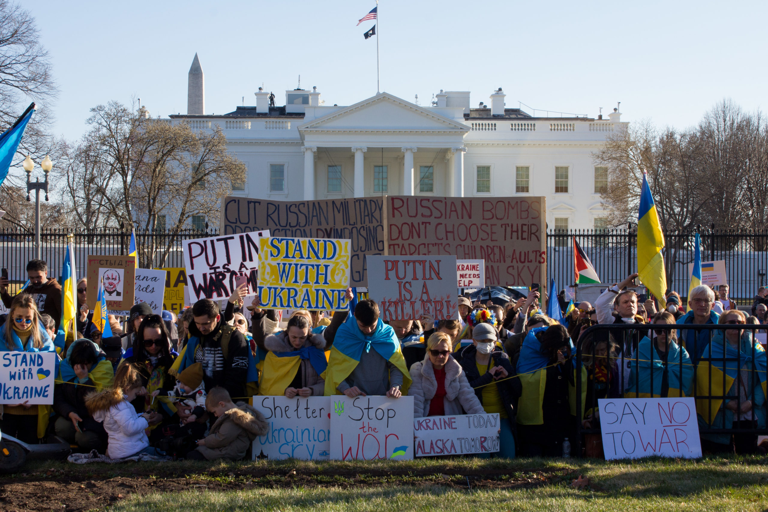 Demonstrators hold signs and flags in support of Ukraine in front of the White House